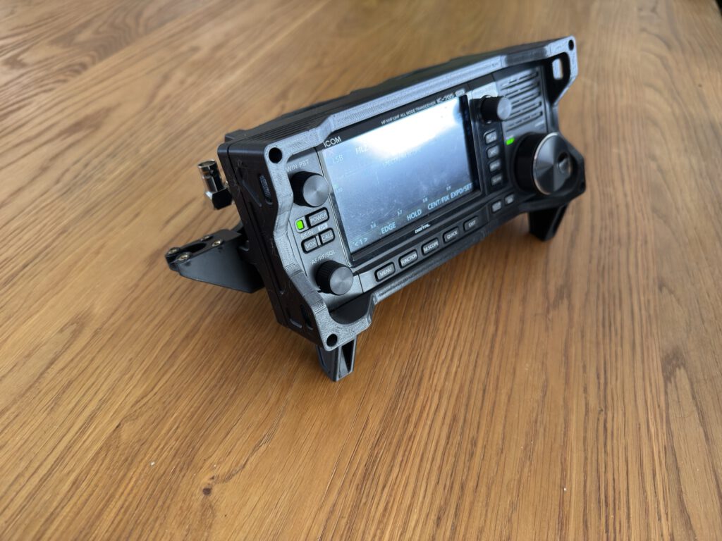 Icom IC-705 in the 3D printed case on a wooden table